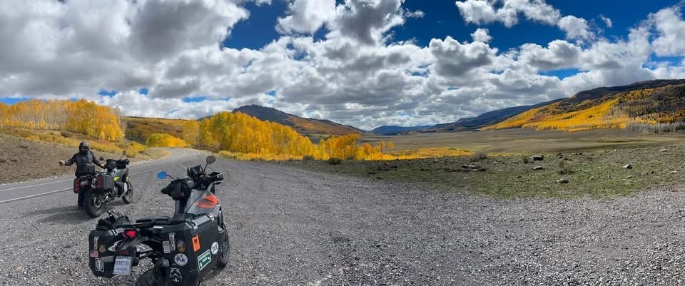 Panoramic Colorado valley two bikes golden aspens