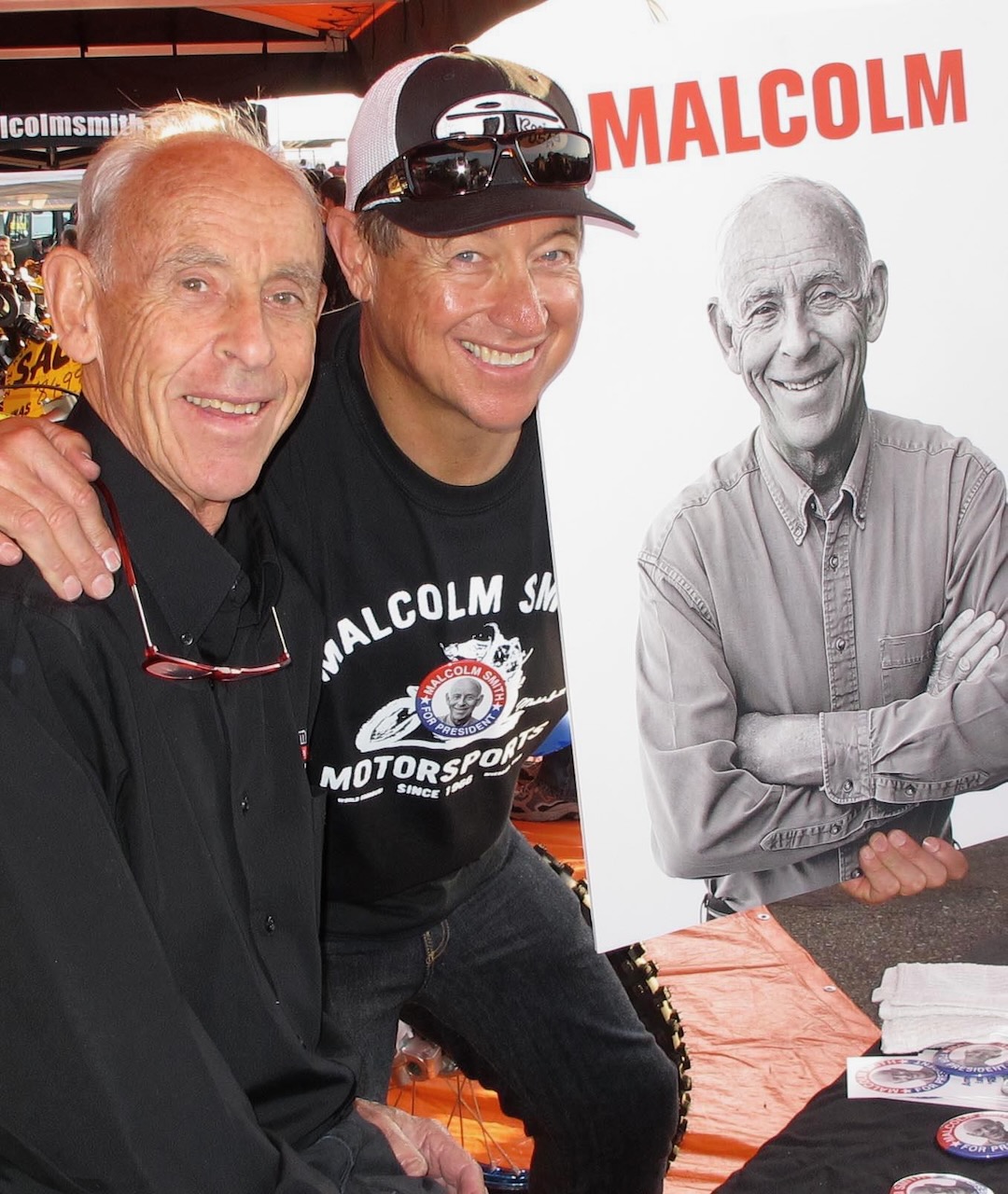 Malcolm Smith and Joe at Malcolm booth with poster