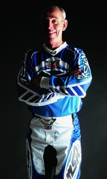 Malcolm Smith in blue and white moto gear arms crossed portrait
